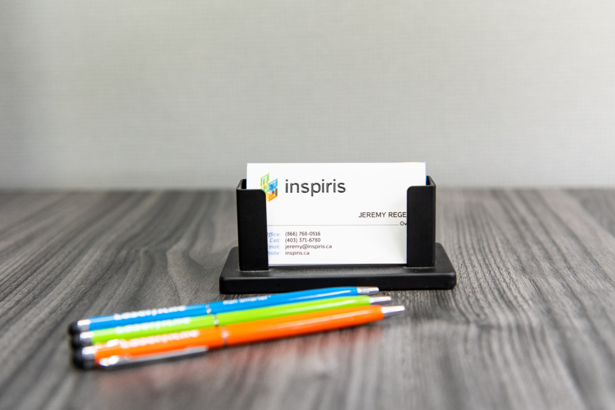 Inspiris - shot of branded pens and business cards